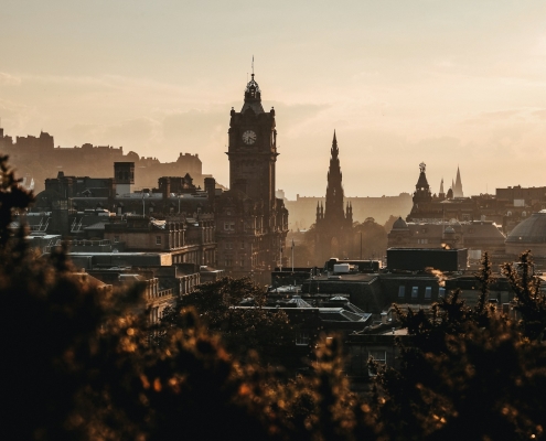 Edinburgh The Balmoral Hotel clock tower and Scott Monument in Edinburgh at golden hour